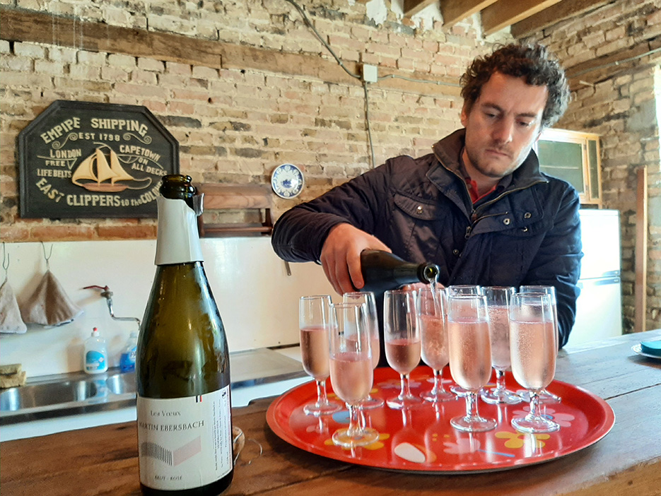 Élaboré et servi par Martin Ebersbach, le vin de la Ferme des Vœux est blanc (rosé) pétillant, élaboré selon une méthode champenoise. 