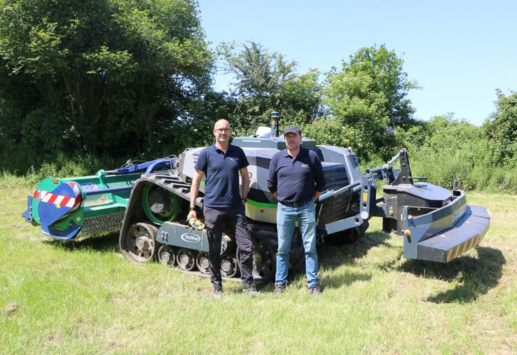 Damien Cousin, responsable Tecmat, et Nicolas Robin, responsable technique, devant l'AgBot T2 de la marque néerlandaise AgXeed.