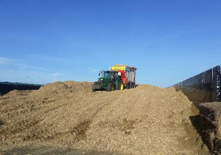 <em class="placeholder">Tracteur John Deere 6R215 et remorque autochargeuse Pöttinger Jumbo 8400 déchargeant la paille de maïs sur un silo</em>
