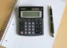 <em class="placeholder">Calculatrice et stylo posé sur un cahier</em>