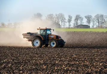 <em class="placeholder">Epandage d'engrais Bio3G stimulateur de croissance qui augmente l'activité microbienne du sol sur un champ labouré avant semis </em>