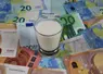 <em class="placeholder">Milk price and agricultural products trend concept: Small glass of milk on euro money bank notes</em>