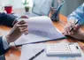 <em class="placeholder">Businesswoman reviewed mortgage document and contract with their client, ensuring loan and credit details were clear, while discussing estate insurance and other finance ...</em>