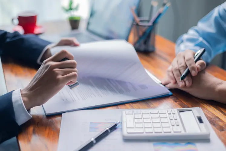 <em class="placeholder">Businesswoman reviewed mortgage document and contract with their client, ensuring loan and credit details were clear, while discussing estate insurance and other finance ...</em>