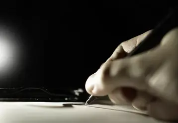 <em class="placeholder">main qui signe un contrat sous fond noir</em>