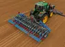 <em class="placeholder">Semoir Monosem MS Electron 18 rangs derrière un tracteur John Deere  au champ</em>
