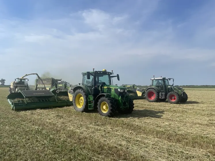 Andaineur à tapis Krone Swativo T 1040 Pro derrière un tracteur John Deere
