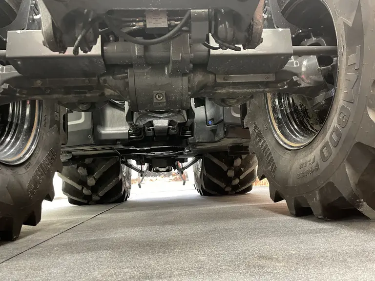 Vue du dessous du pont avant sur le tracteur Valtra série T de sixième génération.