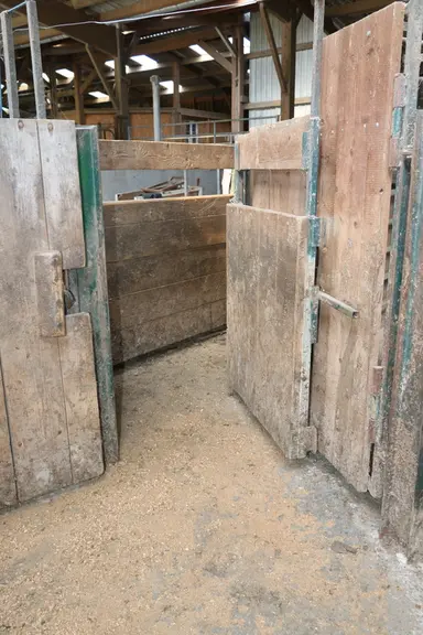 La porte latérale située à l’entrée du couloir de contention est constituée d’un cadre métallique sur lequel ont été boulonnées des planches de dougla