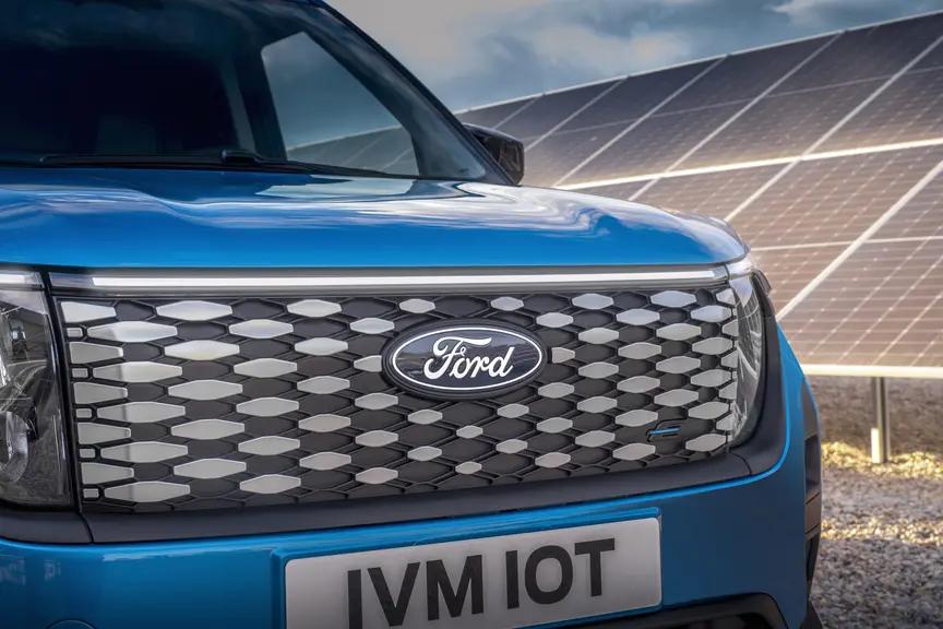 La version électrique de la fourgonnette compacte Ford Transit Courier adopte un calandre spécifique avec un bandeau lumineux.