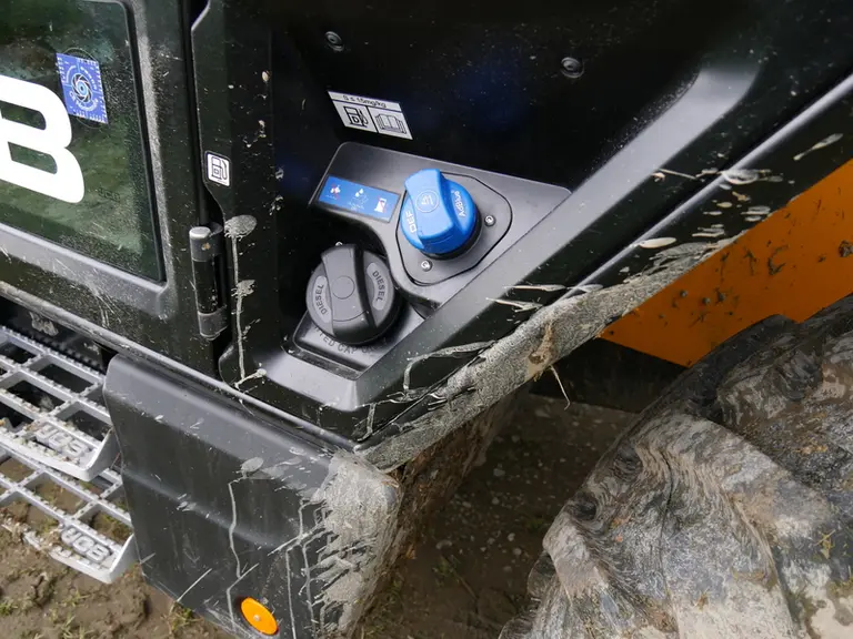 Les bouchons de remplissage de l'AdBlue et du GNR sont regroupés à l'arrière gauche de la cabine du Telescopic JCB 532-70 AgriPro. © D. Laisney