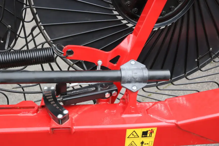 L'andaineur soleil Audax de Tonutti intègre des tubes de relevage des soleils montés sur bagues. Un repère gradué rend le réglage de largeur de l'anda