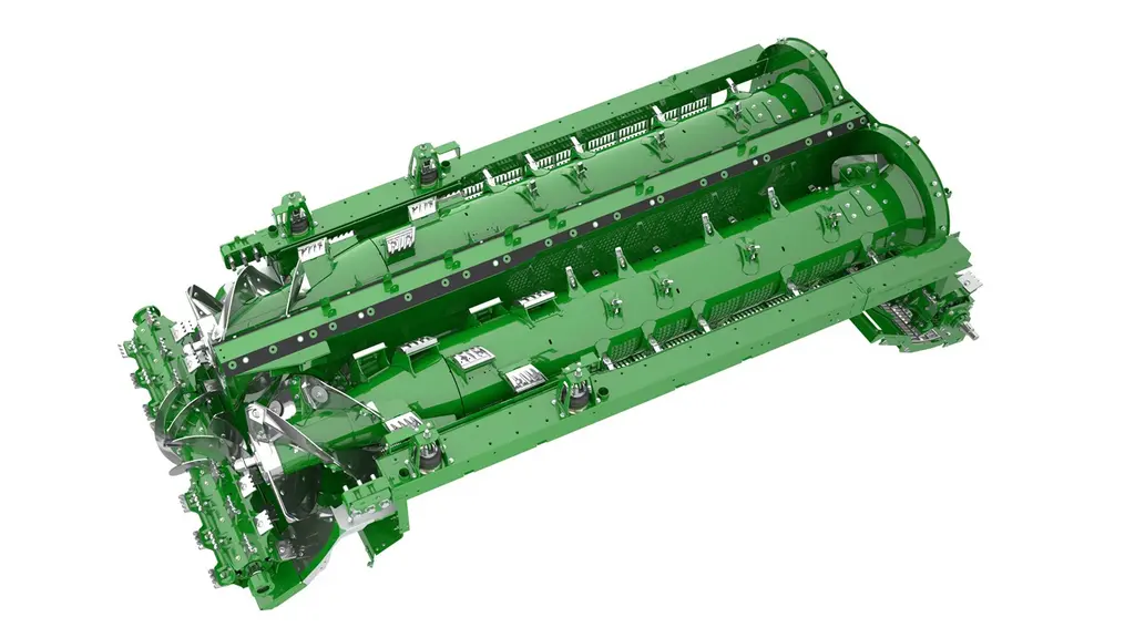 Sur la X9 de John Deere, le rouleau d’alimentation dispose de chevrons divisant le flux en deux pour une bonne répartition de la récolte entre les deu