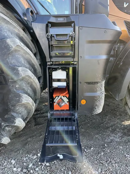 A droite, la porte du compartiment pour le liquide lave-glace et la boîte à outils sert de marchepied. Tenu par des goupilles, le marchepied supérieur