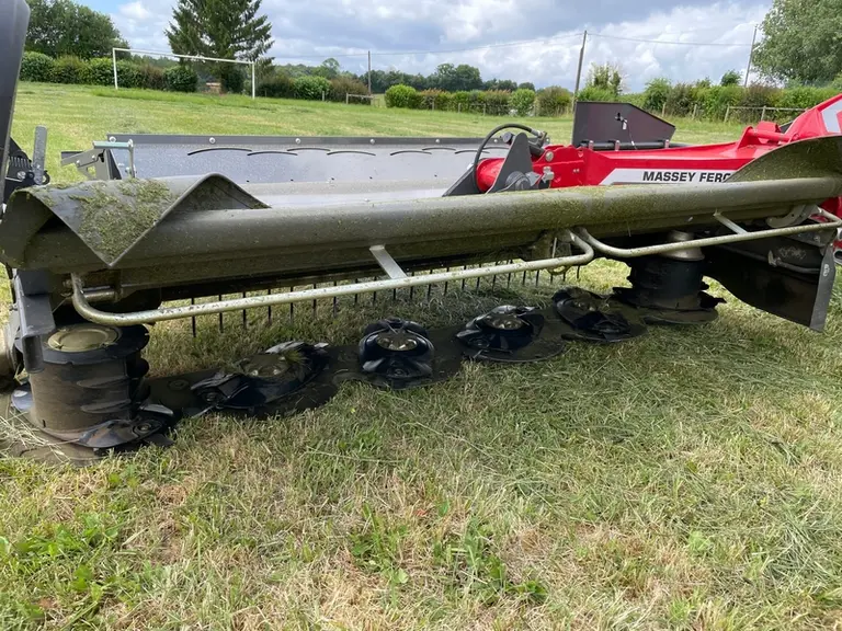 Bâche de protection relevée sur faucheuse à disques Massey Ferguson