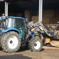 Tracteur transportant une botte de foin