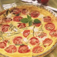 Clafoutis au palet de chèvre frais, courgette et tomates cerise