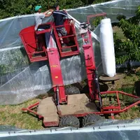 Dépliage de bâches en couverture intégrale sur verger de cerises dans le Rhône.