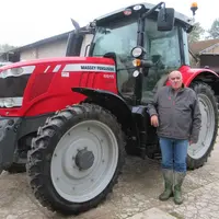 Bernard Cochon, agriculteur, au pied de son tracteur Massey Ferguson.