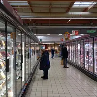 clients devant les vitrines réfrigérées d'un supermarché