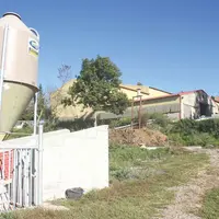 Bâtiment d'élevage avec silo d'aliments.
