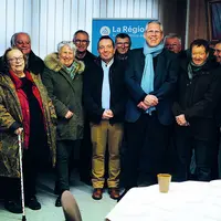 Un groupe de personnes sourient à l'appareil photo.