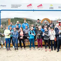 Photo de groupe d'un évènement sportif. Certains portent des médailles.