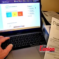 Ordinateur et factures papiers et électroniques.