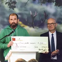 Ludovic Folcher reçoit un chèque des mains du président de la fédération de chasse de Lozère, André Thérond.