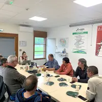 Groupe de gens en réunion autour d'une table