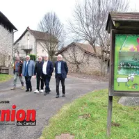 des personnes marchent autour d'une ferme pédagogique qui va accueillir des personnes en situation de handicap à Omps dans le Cantal.