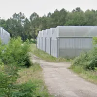 Serres photovoltaïques inoccupées au bout d'un chemin dans les Landes