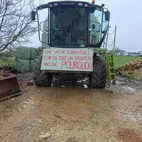 Pancarte contestataire sur une machine agricole devant l’élevage de Pouilley-Français dont les 83 vaches ont été abattues le 2 décembre.