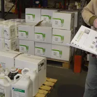 Exploitant agricole et distributeur échangeant prenant livraison d’une commande de produits phytosanitaires.