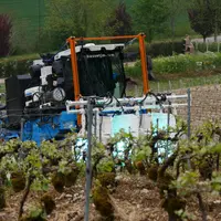 Passage de la machine de stimulation de la vigne aux UV  d'UV Boosting, dans des vignes en pente de Champagne. Au champag