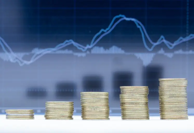 A stack of five rows of coins with graph dark blue background.
