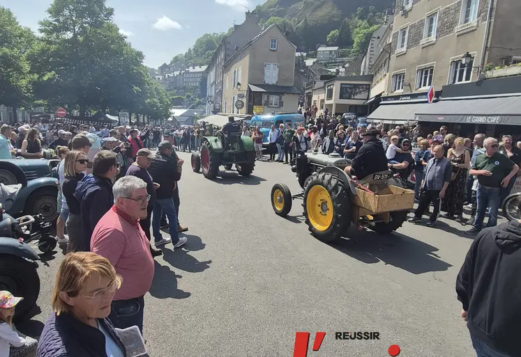 des personnes regardent passer des tracteurs.
