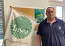 un homme a coté d'un drapeau FNSEA 03