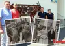 Groupe de personnes posant face à deux photos noir-et-blanc