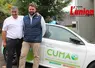 deux hommes devant une voiture siglée FDcuma du Cantal. 