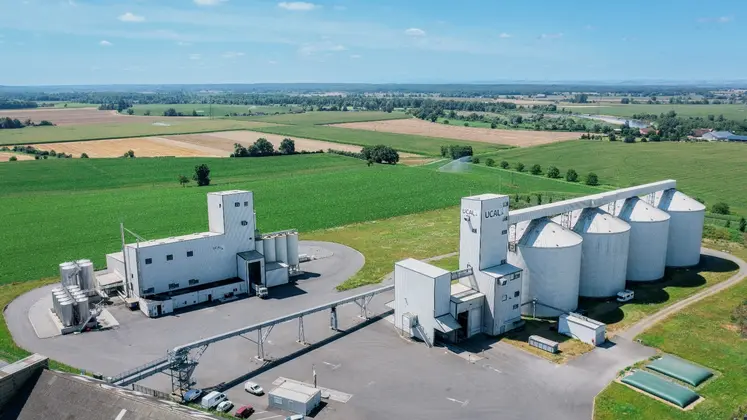 Vue aérienne de l'usine de trituration, comprenant des bâtiments et des silos au milieu de champs