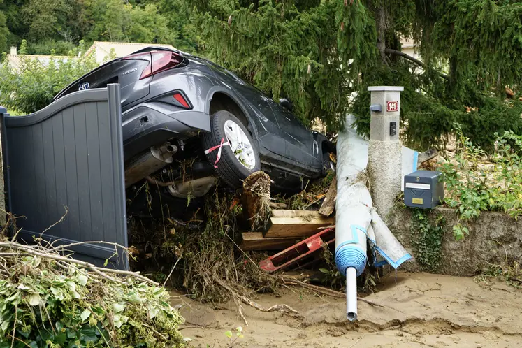 Voiture coincée dans un amas d'objet sur un sol imbibé d'eau