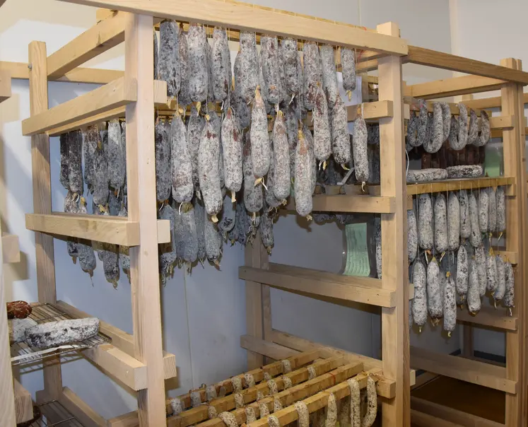 Des montants en bois avec des saucissons suspendus.