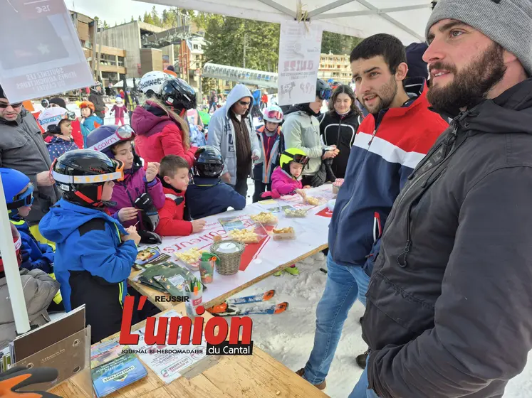 A droite deux hommes et à gauche des enfants avec des casques mangent du fromage