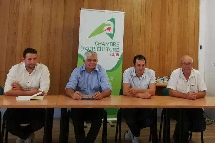 4 hommes assis à un bureau