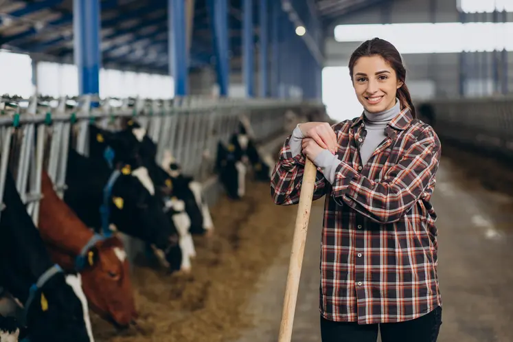 Woman cleaning up at the cowshed