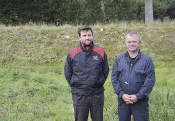 Quentin et André Sergent devant la digue de 2,5 m de haut qui encercle désormais le point bas de l’élevage et de la méthanisation.