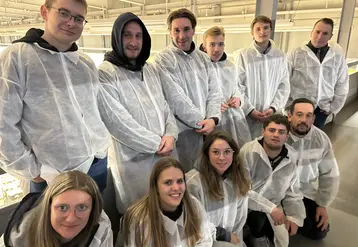 Groupe de jeunes gens en visite à Rungis, revêtus de blouse de protection