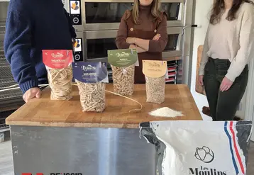 trois personnes derrière une table présentent les paquets de pâtes