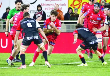 Un joueur de rugby balle en main qui défie un adversaire.